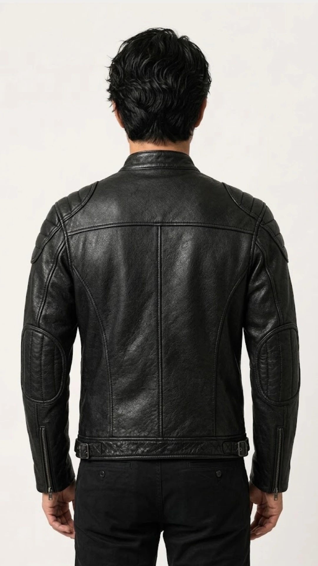 Back view of a man wearing the black vintage leather biker jacket