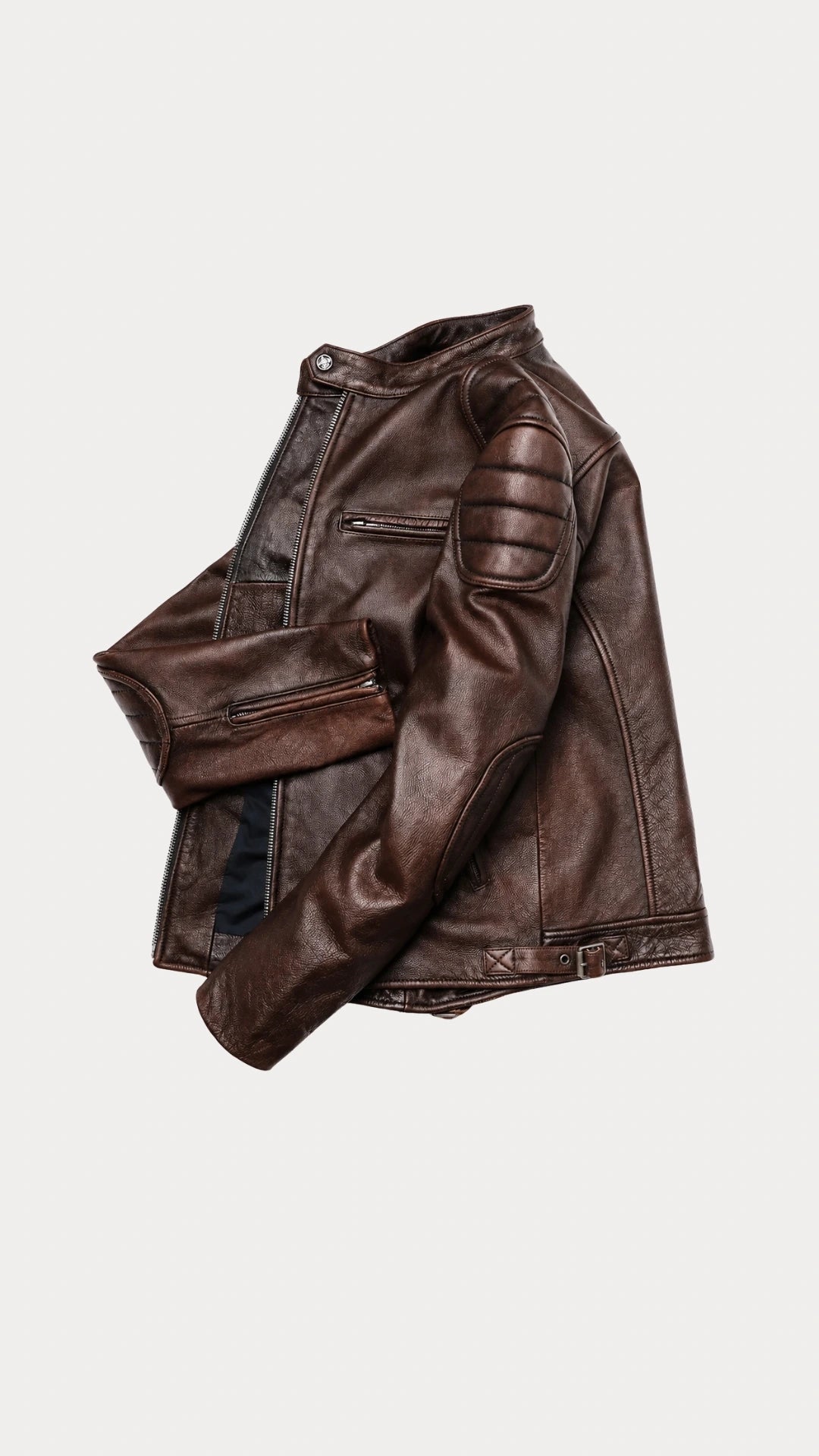 Vintage brown biker jacket folded to show the sleeve and quilted shoulder