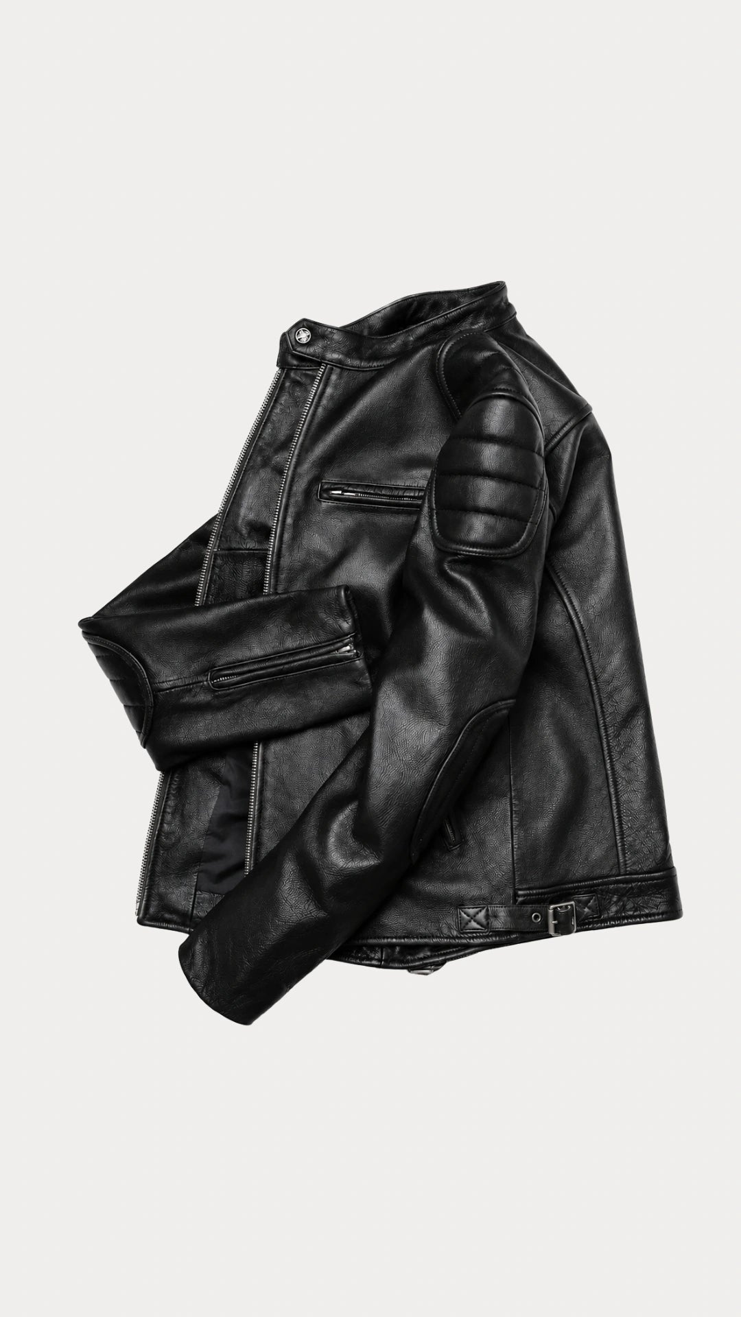 Black biker jacket folded to show the sleeve and quilted shoulder panel